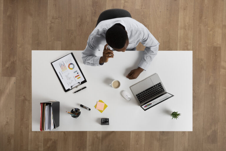 man-working-desk-top-view